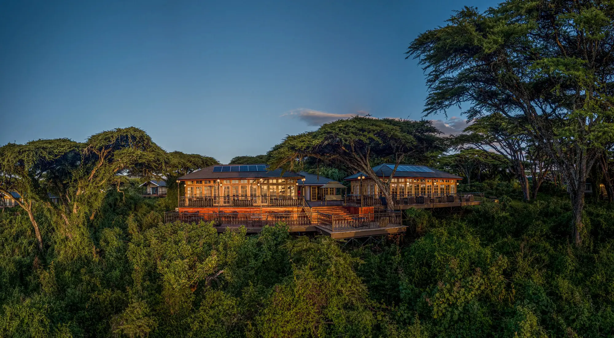 The main lodge among the trees at dusk