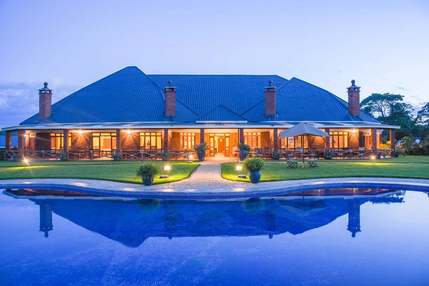 Main lodge reflected in the pool at dusk