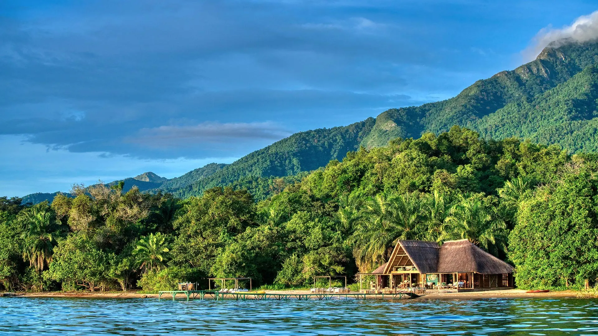 The lodge on the lakeshore below the mountains
