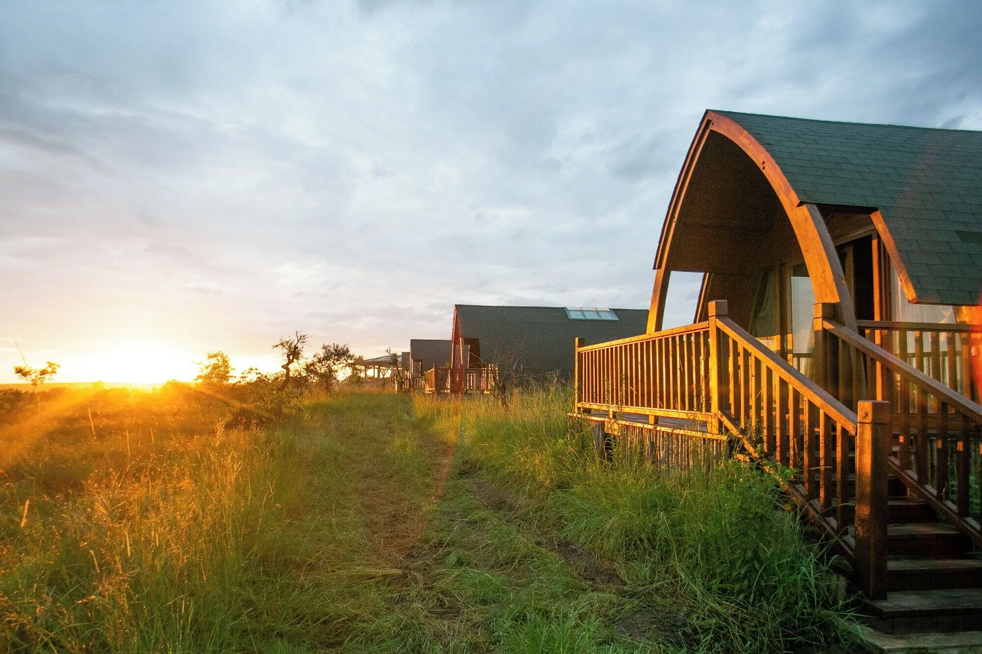 A chalet on its deck at sunset